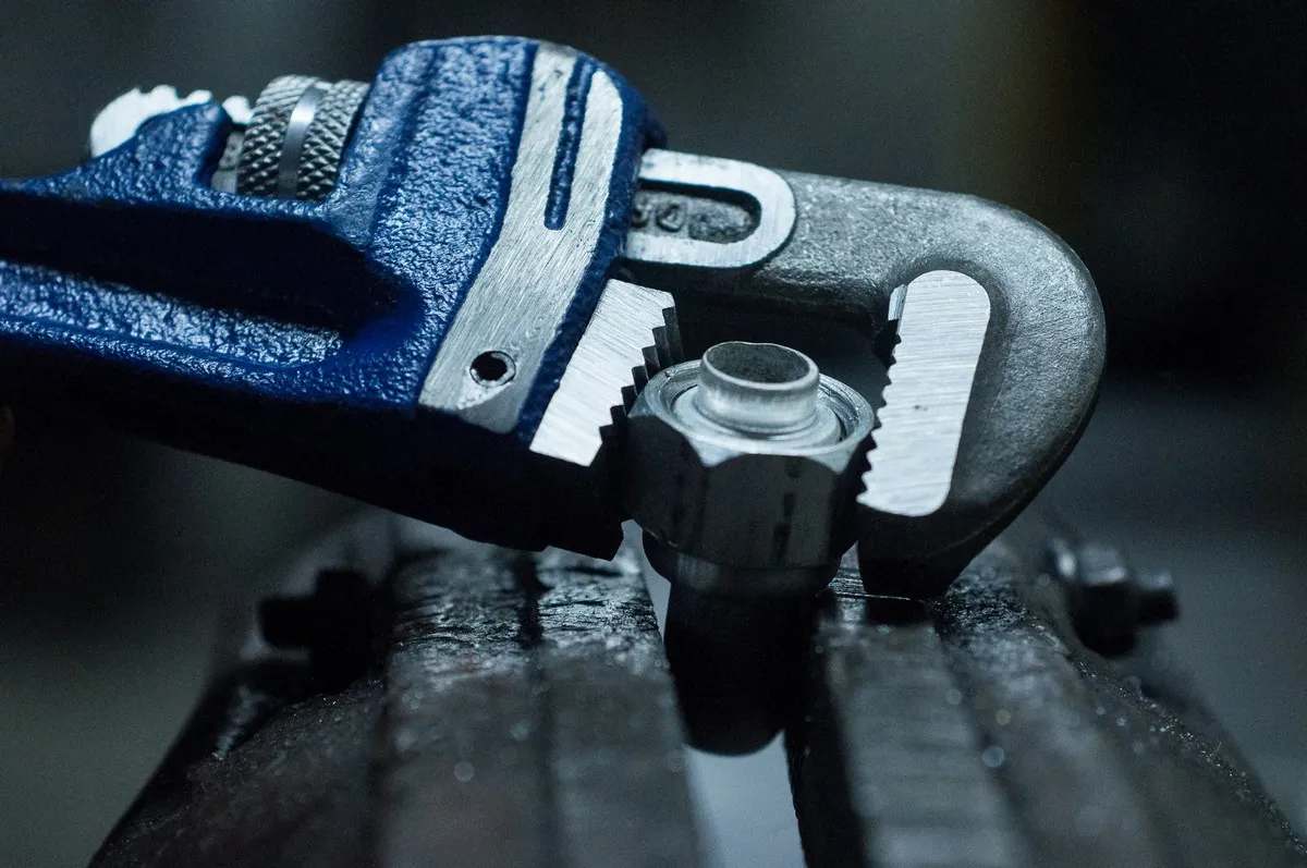 Plumber-using-an-adjustable-wrench